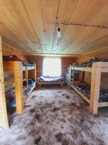 a room with three bunk beds and a window at Горное гнездо и юрты in Mineralʼnyy Istochnik Altyn-Arasan