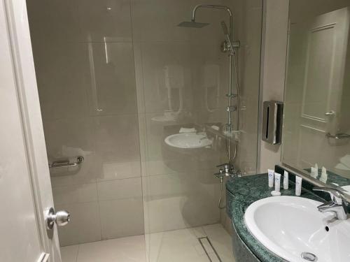 a bathroom with a sink and a shower at Armada Avenue Hotel Amman in Amman