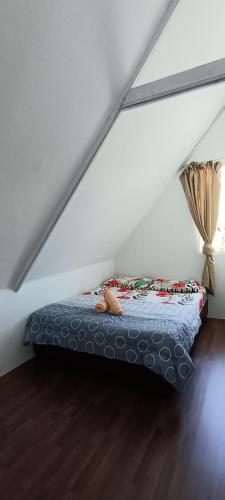 a bed in the attic of a room at Amazing Grace Lodge in Kundasang
