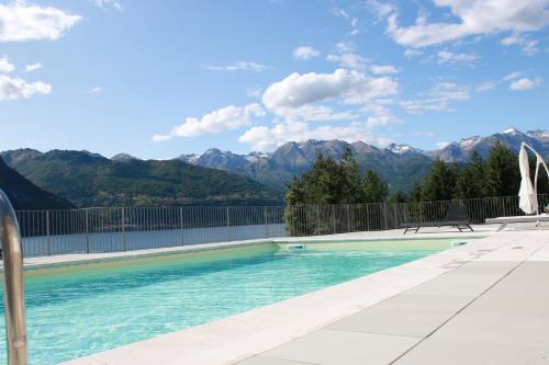 a swimming pool with mountains in the background at Residence Il Poggio in Dorio