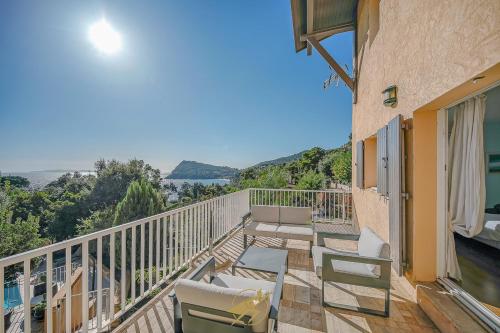 a balcony with chairs and a view of the water at Maison de la Pointe - 4 etoiles - Vue mer - Piscine - Rayol Canadel in Rayol-Canadel-sur-Mer