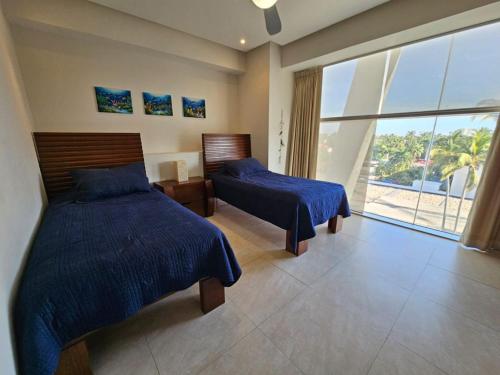 Ένα ή περισσότερα κρεβάτια σε δωμάτιο στο Oceanview Luxury Condo at Peninsula Mazatlán