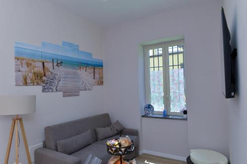 a living room with a couch and a window at L'Aurora Azzurra -Luxury Suites Sorrento coast in Piano di Sorrento