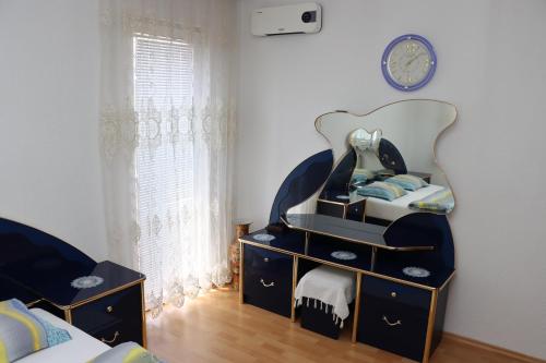 a bedroom with a bed and a dresser with a mirror at Holiday Home Peaceful Retreat in Visoko