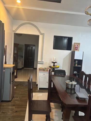 a kitchen and dining room with a table and a dining room gmaxwell gmaxwell at Spacious Home with Great Location in Panabo City in Panabo