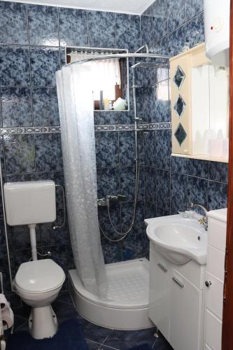 a bathroom with a shower and a toilet and a sink at Holiday Home Peaceful Retreat in Visoko