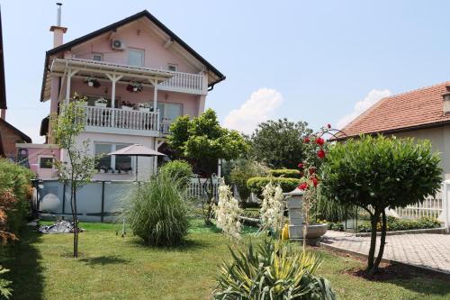 a house with a garden in front of it at Holiday Home Peaceful Retreat in Visoko