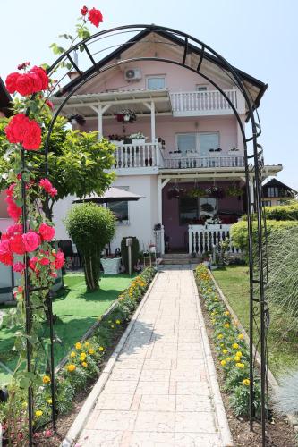 a garden with a walkway in front of a house at Holiday Home Peaceful Retreat in Visoko