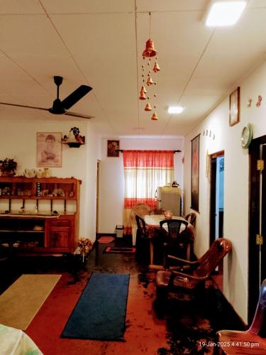 a living room with a table and chairs at Ima Apartment in Galle