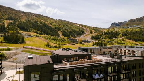 a building with a view of a mountain at Penthouse with large rooftop terrace, Ski In-Ski Out in Hemsedal in Hemsedal