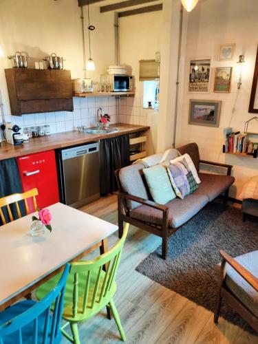 a kitchen and living room with a couch and a table at Cattle Shed Cottage in Narberth