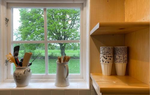 three vases sitting on a window sill in front of a window at 3 Bedroom Awesome Home In Kalmar in Böda
