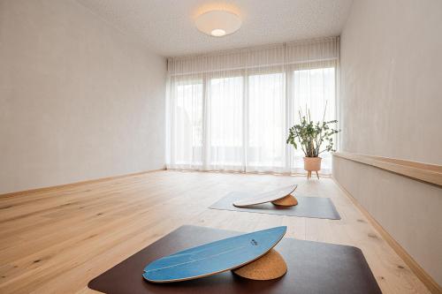 a room with two surfboards sitting on a rug at Hotel Dorfer in Grossarl