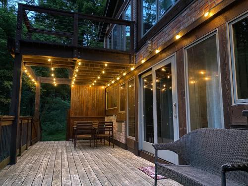a screened porch with lights on a house at Mountain Lodge Retreat, Near New Paltz & Hikes in New Paltz