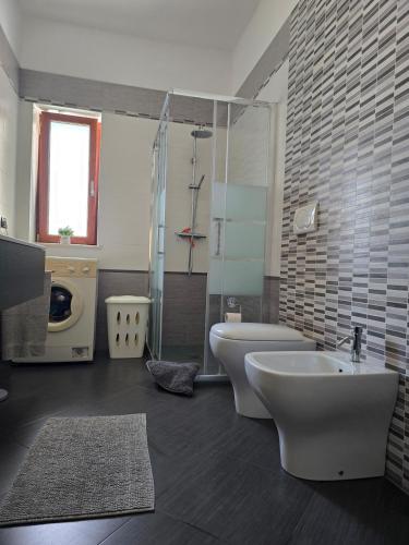 a bathroom with a sink and a toilet and a shower at La Villa di Alice in Vignacastrisi