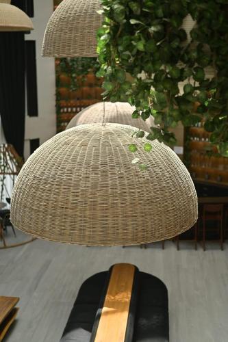 a brown wicker chair with a woodeninylinylinylinylinylinylinylinyl at Yarden Estate Hotel in Yesod Hamaala