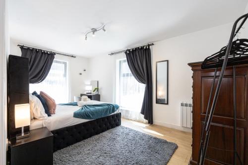 a bedroom with a bed and a large window at Stylish 2-Bed Apartment in Manchester City Centre in Manchester