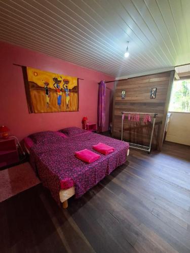 a bedroom with a purple bed in a room at LE Gite DU TOUR DE L'ILE 