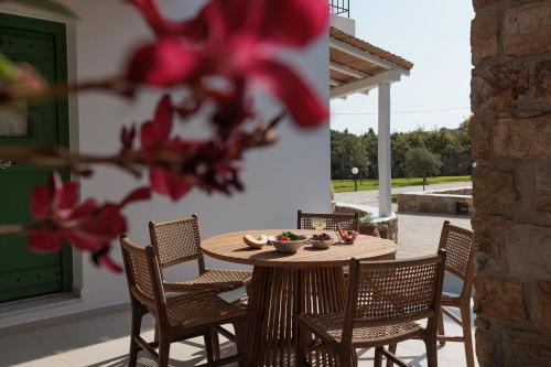 a wooden table and chairs on a patio at Country Villas in Stelida