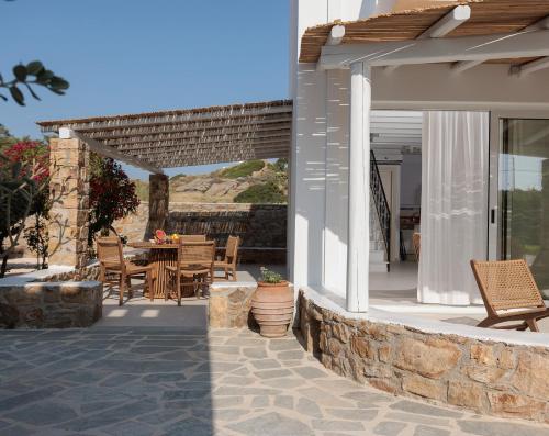 a patio with a table and chairs on a house at Country Villas in Stelida