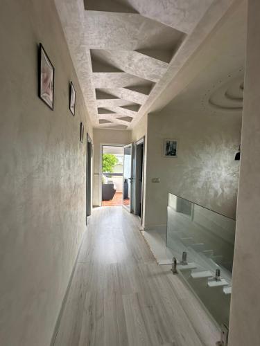 a hallway of a house with wooden floors and ceilings at villa Alcudia SMIR 3 chambre fnedeq restinga tetoin in Fnidek