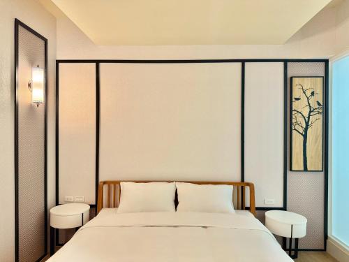 a bedroom with a large bed with two white pillows at Choozme in Lugang