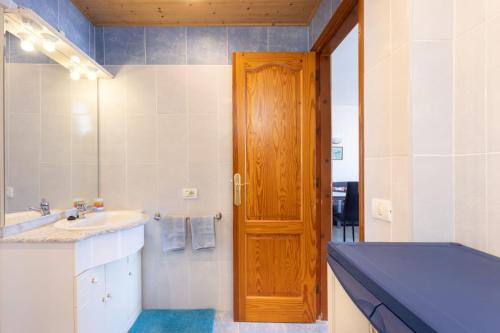 Un baño con lavabo y puerta de madera. en Tenerife View, en Adeje
