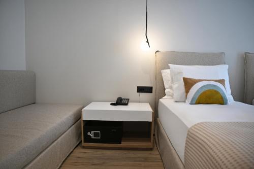 Postel nebo postele na pokoji v ubytování Muze Hotel