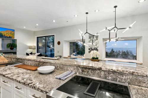 a kitchen with a granite counter top and windows at LUXE 11 Blue Diamond Lodge Lake Tahoe in Stateline