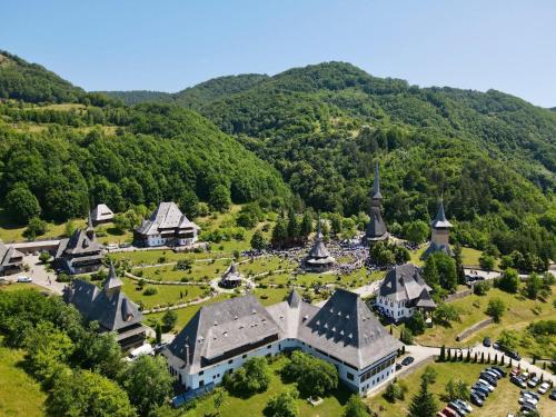 an aerial view of a church in the mountains at Casuta din Cotroape - Maramureș in Săcel