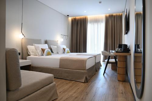 Postel nebo postele na pokoji v ubytování Muze Hotel