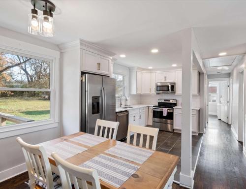 a kitchen with a table and chairs and a refrigerator at Franklin Retreat - Sleeps 4 in Franklin