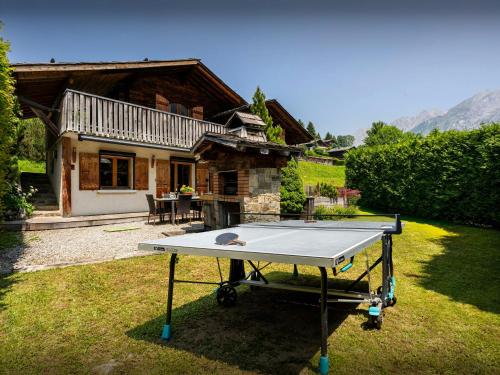 a ping pong table in front of a house at Chalet Le Petit Mazot - OVO Network in La Clusaz
