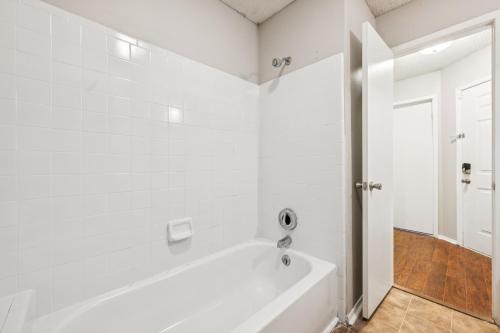a white bathroom with a tub and a shower at The Davis 1824 I Spacious 2 Bed 2 Bath in Huntsville