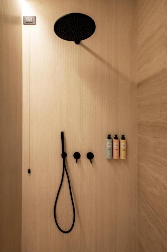 a bathroom with a shower and two bottles ofodorizers at International Hotel & Suite in San Benedetto del Tronto