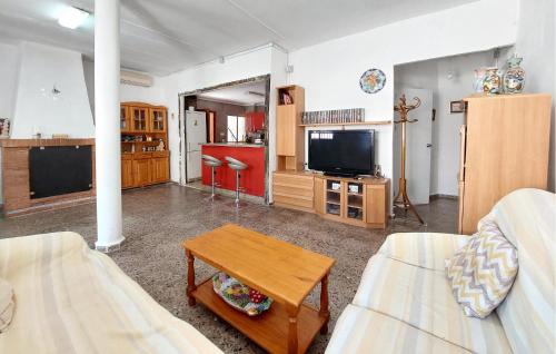 a living room with a couch and a tv at Beautiful Home In Xàtiva With Private Swimming Pool, Can Be Inside Or Outside in Xàtiva
