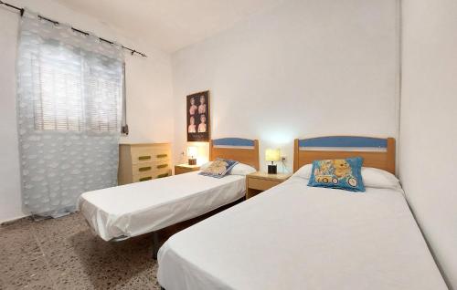 two beds in a small room with a window at Beautiful Home In Xàtiva With Private Swimming Pool, Can Be Inside Or Outside in Xàtiva