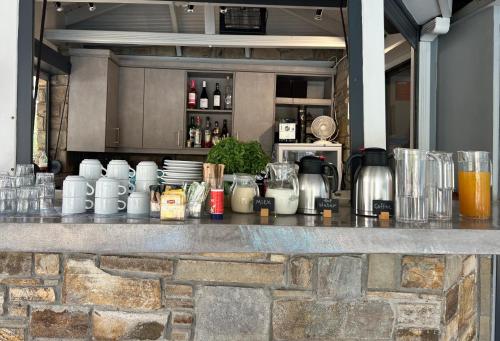 a bar with a counter with drinks and other items at Aliston Hotel Thassos in Skala Potamias
