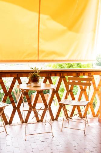 a table and two chairs on a balcony at B&B Casale Ansamagi Relax & Pool in Genzano di Roma