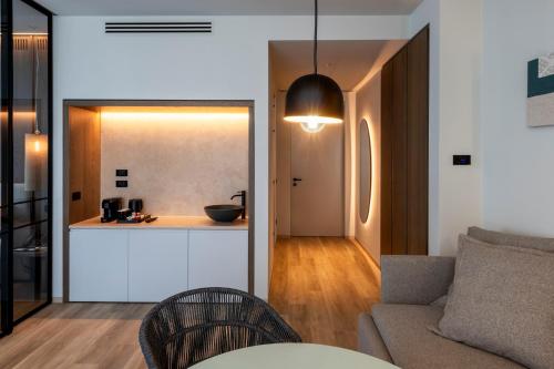 a living room with a couch and a kitchen at International Hotel & Suite in San Benedetto del Tronto