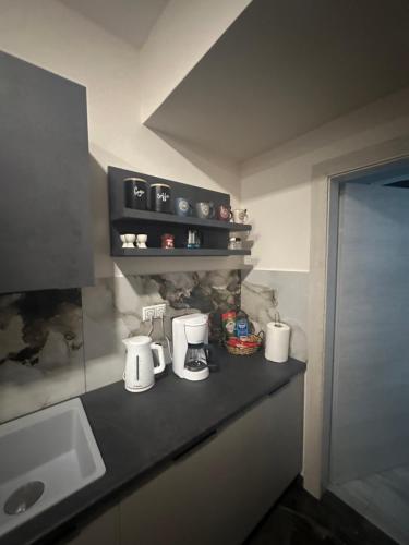 a kitchen counter with three white appliances on it at Ariadni in Kalloni