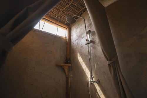 a shower in a bathroom with a window at Mara Hilltop in Sekenani