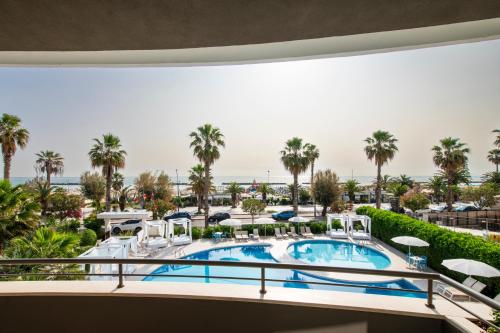 a view of the pool from the balcony of a resort at International Hotel & Suite in San Benedetto del Tronto