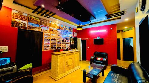 a room with a bar with a red wall at Chandra Safari Hotel Jaisalmer in Jaisalmer