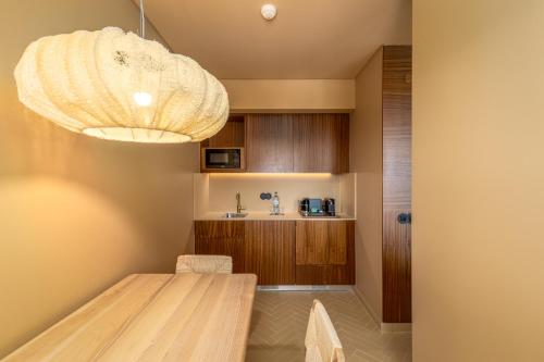 a dining room with a table and a chandelier at 3HB Falesia Beach in Albufeira