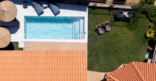 an overhead view of a swimming pool with two chairs at Diosa Luxury Living with Private Pool in Lygaria
