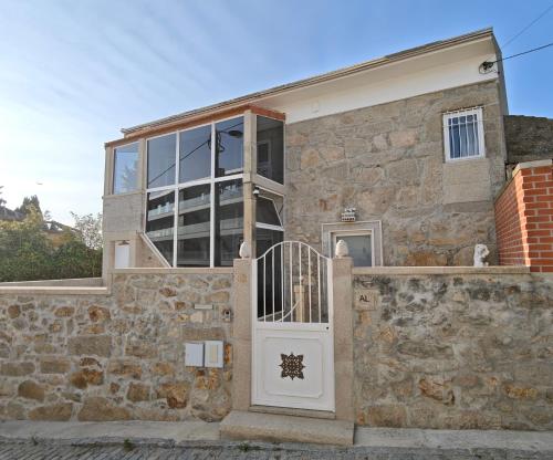 a stone house with a white door at Well at Home in Vila Nova de Gaia
