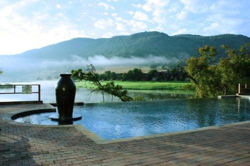 a vase sitting next to a body of water at Kloofzicht Lodge & Spa in Muldersdrift