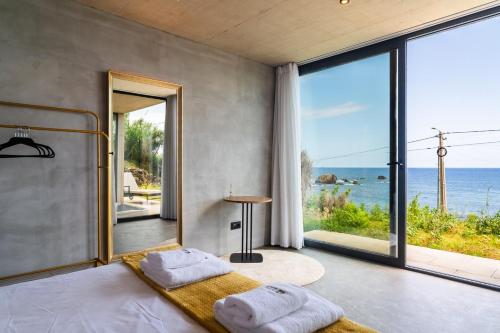 a bedroom with a bed with a view of the ocean at GuestReady - Relax & Ride the Waves in São Vicente