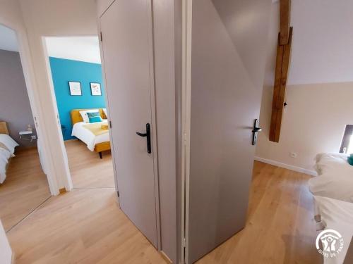 a white closet in a room with a bedroom at Le Logis des Vallées, 6/7 pers avec piscine et sauna in Ambrieres Les Vallees